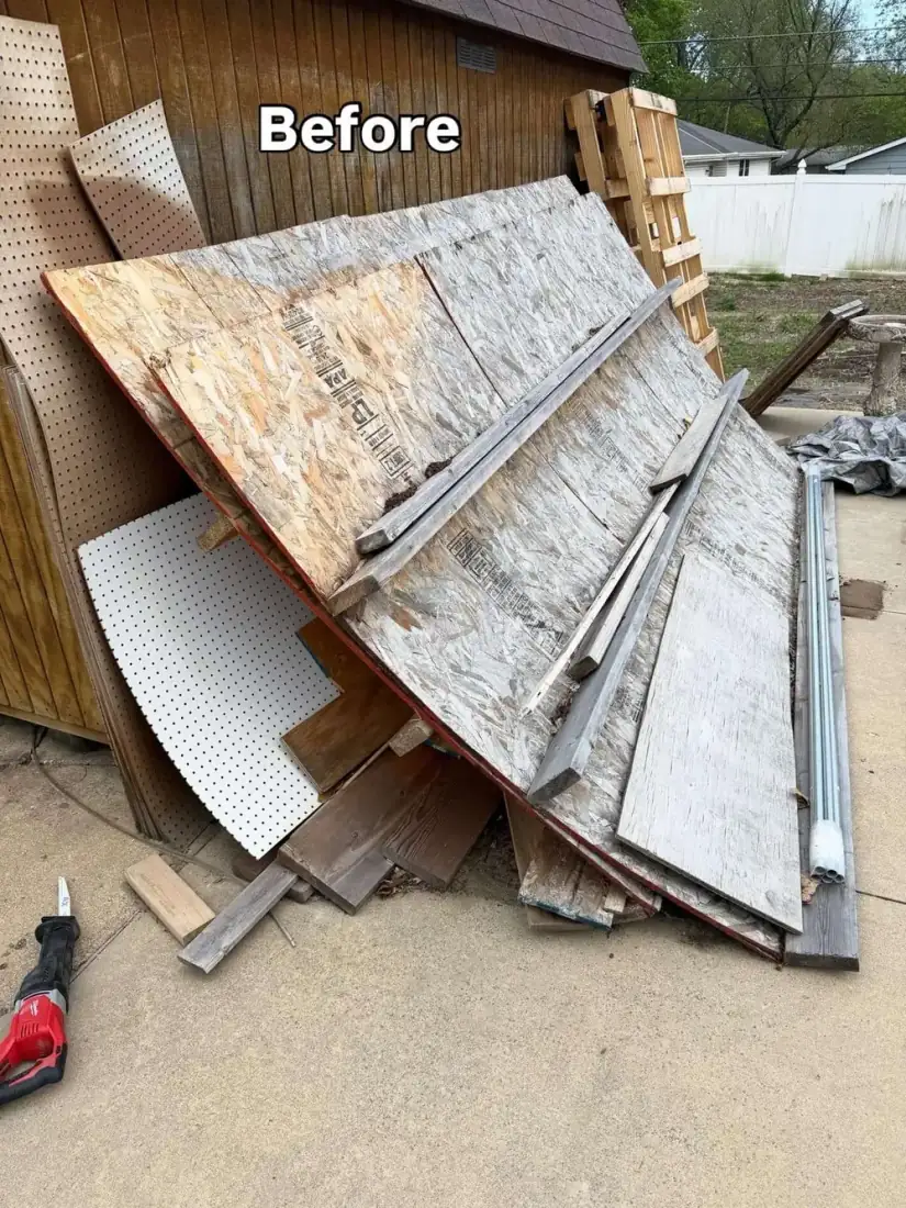 Side yard piled with plywood and lumber scrap from construction before debris removal