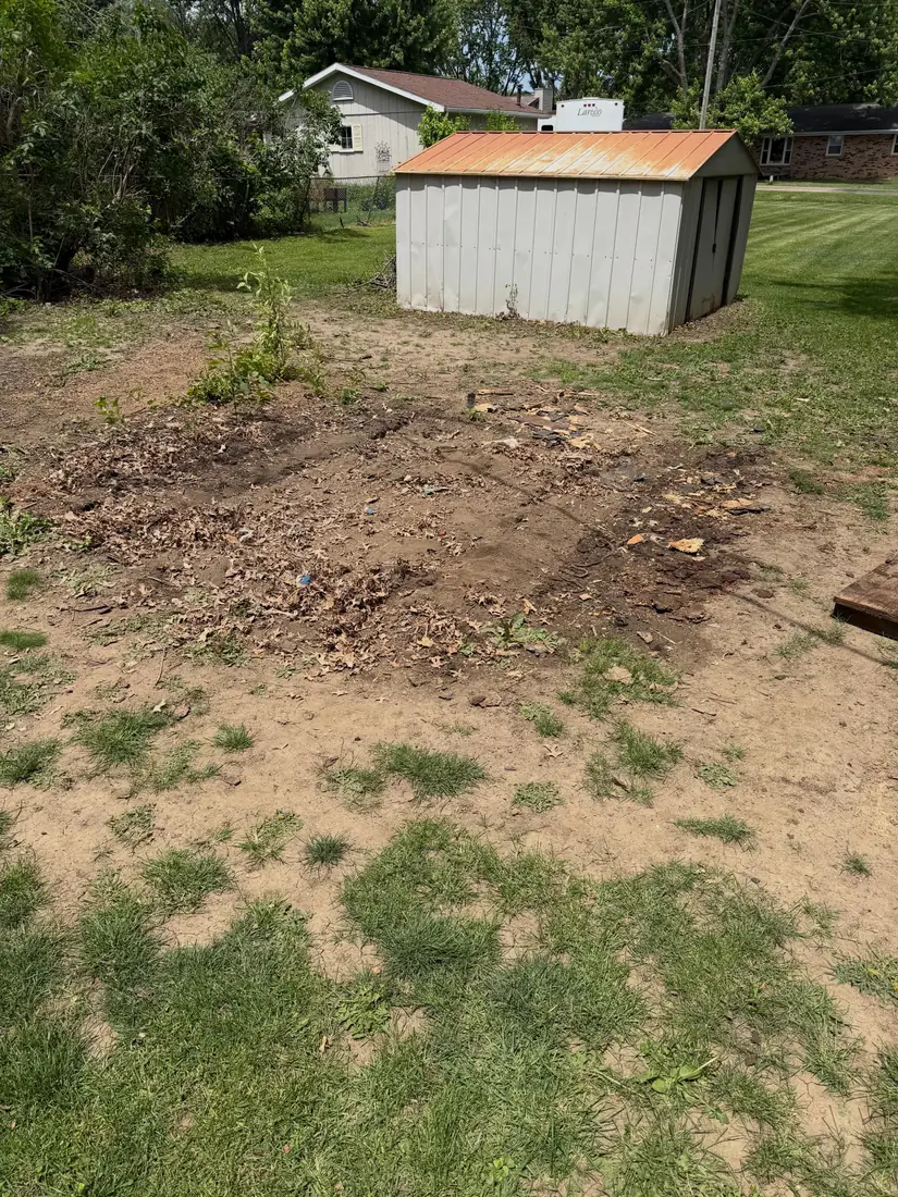 Bare dirt footprint where the backyard shed stood after Speedy Gonzo's tore it down and hauled the debris off