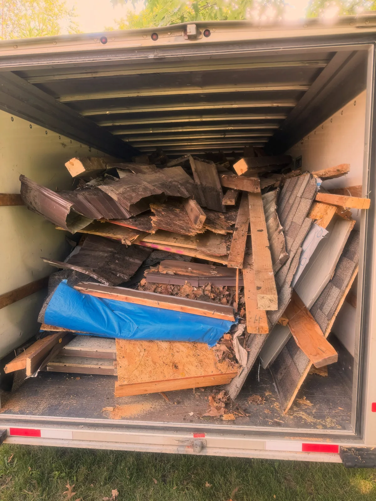 Speedy Gonzo's box truck loaded to the back door with shingles, siding, framing lumber and roof decking from a torn-down backyard shed