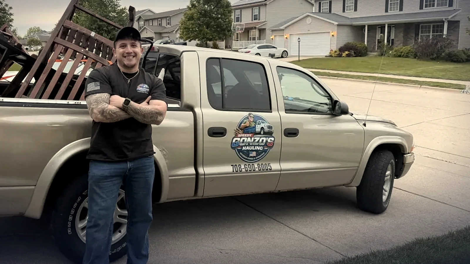 Efren, the veteran owner of Speedy Gonzo's Hauling, standing by his branded truck in Peoria IL